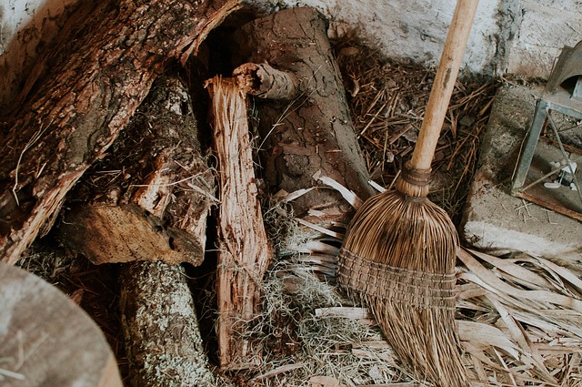 Broom and wooden logs